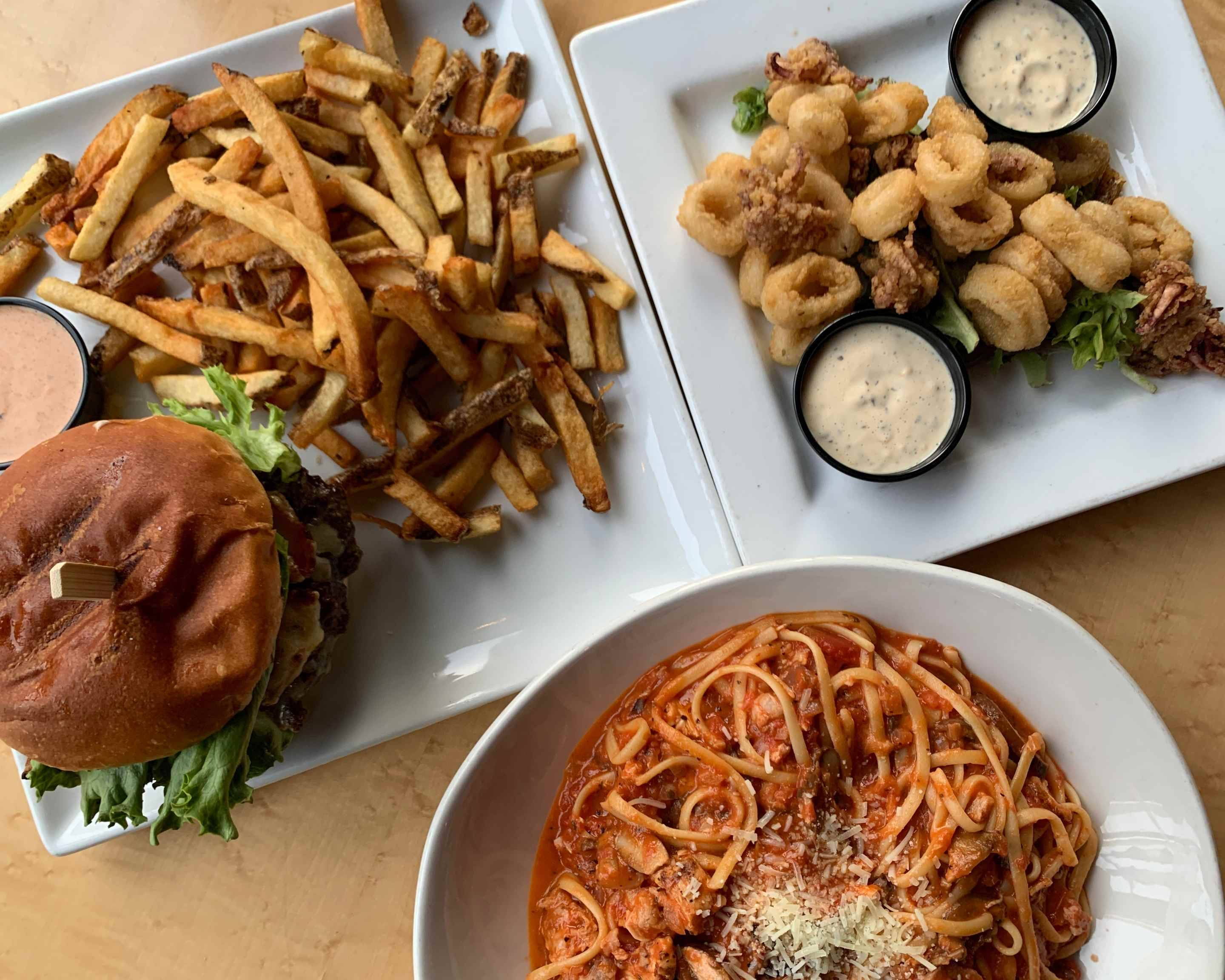 Irresistible image of two mouthwatering dishes from The Grizzly Grill – a freshly baked woodfire pizza and succulent, perfectly grilled ribs. Make your reservations now at Kingston's favorite dining spot. Reserve your table for a delightful culinary experience in Kingston, Ontario!